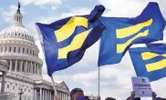  ?? JACQUELYN MARTIN/ASSOCIATED PRESS ?? In July, Human Rights Campaign members hold “equality flags” during an event on Capitol Hill in Washington, in support of transgende­r members of the military.