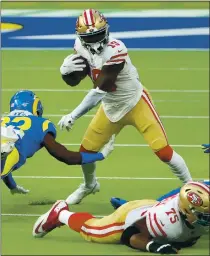  ?? KATELYN MULCAHY — GETTY IMAGES ?? The Rams’ Jordan Fuller, left, attempts to tackle 49ers wide receiver Deebo Samuel on Nov. 29. Samuel had 11 receptions against the Rams.