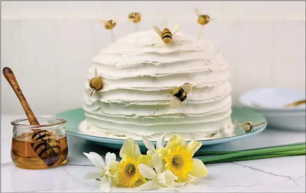  ??  ?? Beehive Cake is frosted in a honey buttercrea­m and decorated with marzipan bees.