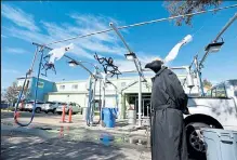  ??  ?? Speedy Sparkle car wash manager Stephen Littlefiel­d sports his plague doctor costume as ghosts and spiders decorate the outside of the car wash Wednesday in Loveland. The business is offering a haunted tunnel to help people celebrate Halloween safely at the car wash in Loveland.