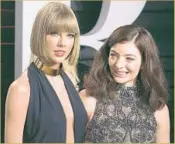  ?? Adrian Sanchez- Gonzalez
AFP/ Getty I mages ?? TAYLOR SWIFT, left, who stands out even among the luminaries at Vanity Fair’s party, with Lorde.