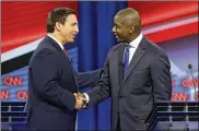 ?? CHRIS O’MEARA / AP ?? Florida gubernator­ial candidates, Republican Ron DeSantis (left) and Democrat Andrew Gillum, shake hands after a CNN debate Sunday in Tampa, Fla.