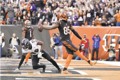  ?? JEFF DEAN/AP ?? Bengals wide receiver Tee Higgins catches one of his two touchdowns against Ravens cornerback Daryl Worley in the second half on Sunday in Cincinnati.