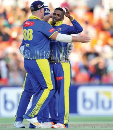  ??  ?? IT’S THE SIZE OF THE FIGHT... Cape Cobras breakout player this season, Ferisco Adams, right, is congratula­ted by teammates on taking a wicket.