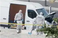  ?? AP ?? Police officers inspect the van after it rammed into two bus stops in the French port city of Marseille on Monday. —