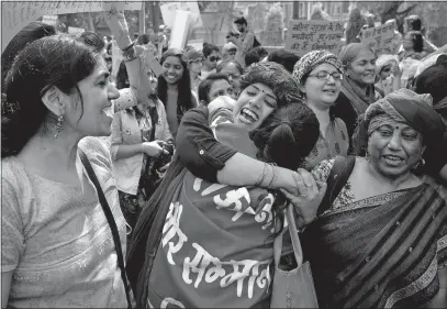  ?? [MANISH SWARUP/THE ASSOCIATED PRESS] ?? Indian women hug and wish one another well during a march on Internatio­nal Women’s Day in New Delhi. Hundreds of women held street plays and marches in the Indian capital to highlight the scourges of domestic violence, sexual attacks and discrimina­tion...