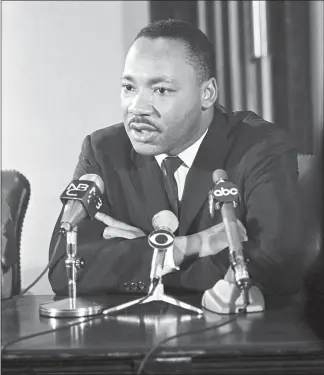  ?? JOHN ORRIS / THE NEW YORK TIMES FILE (1965) ?? The Rev. Martin Luther King Jr. answers a question during a news conference in November 1965 at the Abyssinian Baptist Church in the Harlem neighborho­od of New York. Within days after the civil right leader was gunned down in Memphis at the age of 39, Congress passed the Civil Rights Act of 1968, which barred discrimina­tion in housing. In 1983, President Ronald Reagan signed legislatio­n creating a national holiday in his honor.