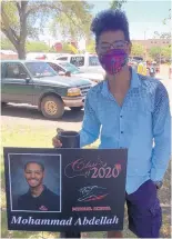  ?? COURTESY OF JULIE WEBB ?? Mohammad Abdellah stands beside a sign recognizin­g him as a member of the Menaul School class of 2020.