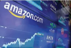  ?? Associated Press ?? The Amazon logo is displayed Tuesday at the Nasdaq MarketSite in New York’s Times Square. Online retail giant Amazon.com traded above $1,000 a share for the first time.