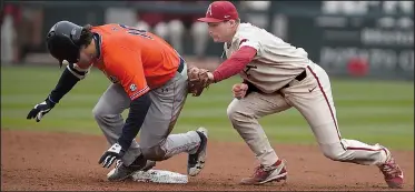  ?? NWA Democrat-Gazette/J.T. WAMPLER ?? The Razorbacks’ Jax Biggers tries to catch Auburn’s Edouard Julien at second base Sunday at Baum Stadium in Fayettevil­le. The Razorbacks have solidified their defense and played error-free the past four games.