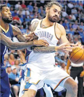  ?? BILLINGS, THE OKLAHOMAN] [PHOTO BY NATE ?? Oklahoma City’s Steven Adams tries to keep control of the ball as New Orleans’ Perry Jones defends during Friday’s preseason NBA basketball game between the Oklahoma City Thunder and the New Orleans Pelicans at Chesapeake Energy Arena.