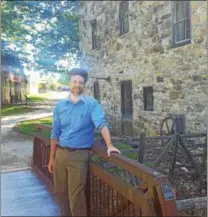  ??  ?? Will Caverly, new executive director at the Mill at Anselma, poses at the new work place.