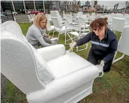  ?? PHOTO: JOHN KIRK-ANDERSON/FAIRFAX NZ ?? Maria Roe, left, and Karen Clarke apply a touch-up to the 185 white chairs earthquake memorial.