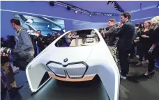  ?? WALDEN KIRSCH, INTEL CORP. ?? Crowds gather to see a BMW prototype vehicle at the BMW Group news conference Wednesday at CES in Las Vegas.