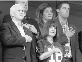  ?? SAM RICHE/TNS ?? Vice President Mike Pence, left, and his wife, Karen, right, stand during the national anthem before Sunday’s game between the Indianapol­is Colts and San Francisco 49ers.