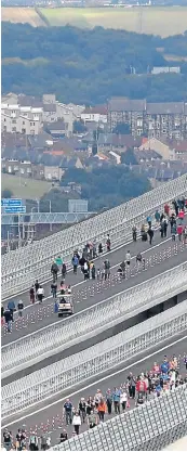  ?? Pictures: PA. ?? Above and right: walkers take to the crossing for the only time, as it will not be open to pedestrian­s.