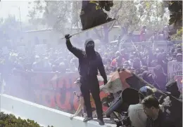  ?? AP FILE PHOTO ?? HOOLIGANS ON THE LEFT: Masked antifa members — pictured here at a Berkeley, Calif., rally — aren’t entitled to a get-out-of-jail free pass for their violent tactics.