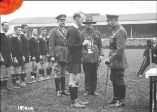  ??  ?? King George V presents the King’s Cup to James Ryan, captain of the victorious NZ side, at Twickenham, 19 April 1919. The NZ team included six All Blacks and won the final 9 to 3 against the ‘Mother Country’.