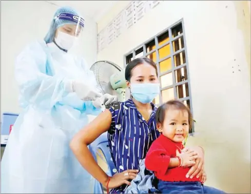  ?? HENG CHIVOAN ?? A woman gets vaccinated against Covid-19 at the Pochentong Referral Hospital in Phnom Penh’s Por Sen Chey district on Tuesday.