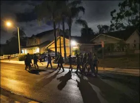  ?? RICHARD VOGEL — THE ASSOCIATED PRESS ?? DEA agents move in on a residentia­l house during an arrest of a suspected drug trafficker on March 11 in Diamond Bar