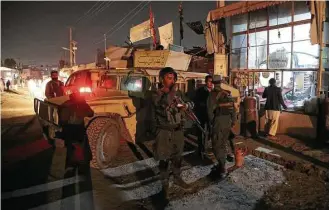  ?? Rahmat Alizadah / Sipa USA / Tribune News Service ?? Afghan security forces guard the site of an attack Friday on a Shiite mosque in the capital of Kabul. Another bombing Friday occurred in the western Ghor province.