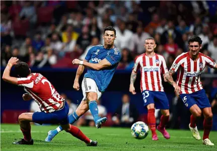  ??  ?? Quiet night: Juventus’ Cristiano Ronaldo (second from left) shoots during the Champions League Group D match against Atletico Madrid at the Wanda Metropolit­ano Stadium on Wednesday. — AFP