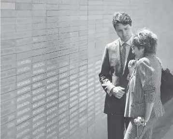  ?? SEAN KILPATRICK / THE CANADIAN PRESS ?? Prime Minister Justin Trudeau comforts Nora Patrich of Vancouver as they visit the Parque de la Memoria. Patrich lost her husband and six other family members when they were killed by the Argentine military junta.