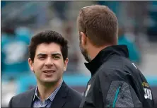  ?? Associated Press ?? Big words: Jacksonvil­le Jaguars senior vice president Tony Khan, left, talks with an unidentifi­ed person prior to an NFL game against the Buffalo Bills in Jacksonvil­le, Fla.