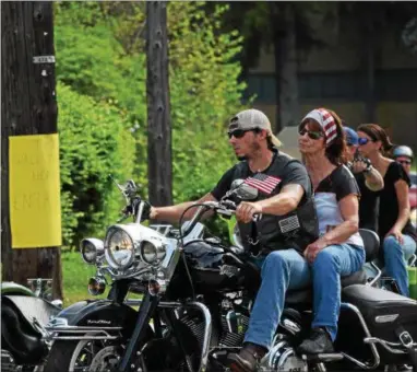  ?? MARIAN DENNIS – DIGITAL FIRST MEDIA ?? Motorcycli­sts sporting patriotic attire escorted the mobile memorial down High Street Thursday.