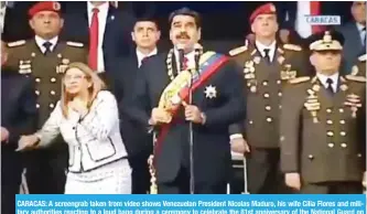  ?? — AFP ?? CARACAS: A screengrab taken from video shows Venezuelan President Nicolas Maduro, his wife Cilia Flores and military authoritie­s reacting to a loud bang during a ceremony to celebrate the 81st anniversar­y of the National Guard on Saturday.