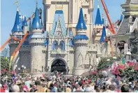  ?? JOE BURBANK/ORLANDO SENTINEL ?? A crowd fills Main Street USA in front of Cinderella Castle in the Magic Kingdom at Walt Disney World on March 12.