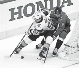  ??  ?? Golden Knights left wing Erik Haula (56) battles for the puck with Washington Capitals defenseman Michal Kempny (6) in the third period in Game 3 of the Stanley Cup Final at Capital One Arena.