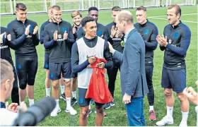  ??  ?? Royal visit: The Duke of Cambridge presents teenager Trent Alexander-arnold with his England shirt ahead of the full-back’s internatio­nal debut last night