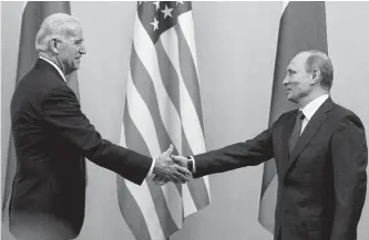  ?? REUTERS FILE ?? Russian Prime Minister Vladimir Putin, right, shakes hands with then-u.s. Vice-president Joe Biden during a meeting in Moscow on March 10, 2011. The two, with Biden now U.S. president, are set to meet in Geneva today.