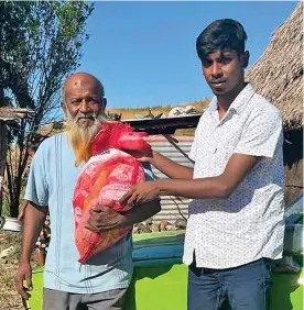  ?? ?? One Nation Our People Youth Club founder and president, Abdul Zorhab (right) after donating groceries to Sheik Sokhat Ali at his home in Nasau, Nadi