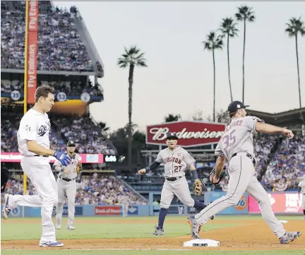  ?? DAVID J. PHILLIP/THE ASSOCIATED PRESS ?? Los Angeles Dodgers pitcher Rich Hill is out at first base as Houston Astros starter Justin Verlander covers during the third inning of Game 2 of the World Series on Wednesday in Los Angeles. Hill lasted four innings, striking out seven and allowing a...