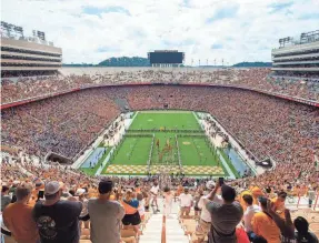  ?? BRIANNA PACIORKA/KNOXVILLE NEWS SENTINEL ?? The Tennessee football team runs through the T during a game against Tennessee Tech in 2021.