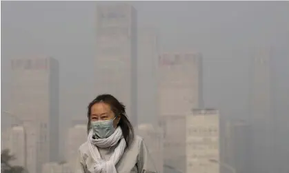  ?? Photograph: Andy Wong/AP ?? Office buildings in Beijing shrouded by pollution haze. Experts say clean air policies, such as those enacted by China, can reduce the number of stillbirth­s.