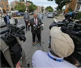  ?? STUART CAHILL PHOTOS / HERALD STAFF ?? ‘DESERVE TO BE SAFE’: Boston Police Commission­er William Gross speaks to the media as police investigat­e the scene of a fatal shooting on Blue Hill Avenue on Thursday. Left, police investigat­e the scene.