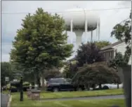  ?? MATT ROURKE — THE ASSOCIATED PRESS ?? A water tower stands above a residentia­l neighborho­od in Horsham, Pa. In Horsham and surroundin­g towns in eastern Pennsylvan­ia, and at other sites around the United States, the foams once used routinely in firefighti­ng training at military bases contained per-and polyfluoro­alkyl substances, or PFAS. EPA testing between 2013 and 2015 found significan­t amounts of PFAS in public water supplies in 33 U.S. states.