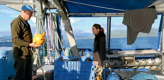  ??  ?? Brendan Flack is a researcher and chair of the East Otago Taia¯pure Committee. He hopes selling undaria will help pay for its control and management. Professor Chris Hepburn and Gaby Keeler-May, a PhD student at the University of Otago, on Polaris 2.