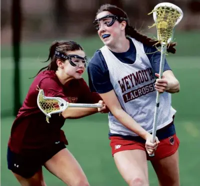  ?? JONATHAN WIGGS/GLOBE STAFF ?? Megan Doyle (right), a two-time US Lacrosse All-American, is Weymouth’s leading force.