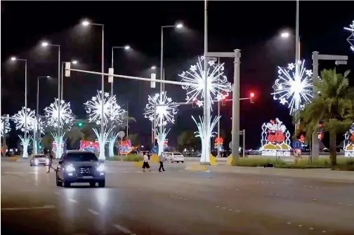  ?? ?? ↑
An area lit up for Eid in Abu Dhabi.