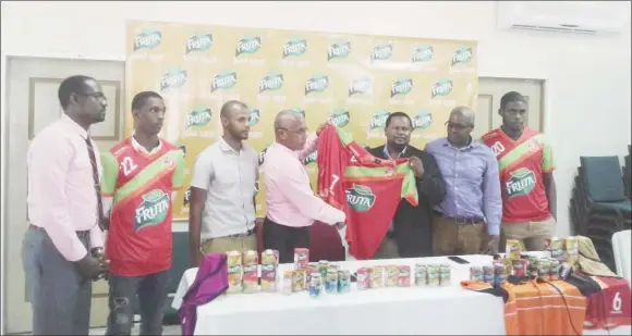  ??  ?? Samuel Arjoon (third from right), Commercial Manager of GBI, hands over the symbolic jersey to Fruta Conquerors Assistant Secretary/Treasurer Jolyan Lewis, in the presence of several members of the club and company. From left to right-Club Secretary...