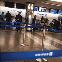  ?? JOHN TAGGART / THE NEW YORK TIMES 2017 ?? Passengers check in at United Airlines counters in New York’s LaGuardia Airport. United raised its checked-bag fees this month, following the lead of JetBlue.