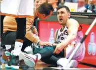  ?? GREGORY SHAMUS / GETTY IMAGES / AFP ?? Andrew Bogut grimaces in pain after breaking his leg a minute into his Cleveland Cavaliers debut against the Miami Heat on Monday in Cleveland, Ohio.