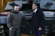  ?? ANDREW MATTHEWS — POOL VIA AP ?? British Prime Minister Rishi Sunak, right, and Ukrainian President Volodymyr Zelensky meet Ukrainian troops being trained to command Challenger 2tanks at a military facility in Lulworth, Dorset, England, on Wednesday.