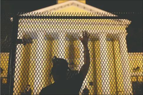  ?? (File Photo/AP/Maya Alleruzzo) ?? A protester calls out to police standing guard behind security fencing at St. John’s Episcopal Church, near the White House on June 24 amid continuing anti-racism demonstrat­ions following the death of George Floyd.