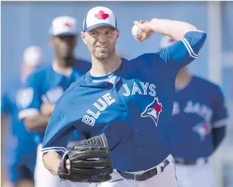  ?? FRANK GUNN, THE CANADIAN PRESS ?? Blue Jays starter J.A. Happ does some light work at spring training on Wednesday. The left-hander, who was 10-11 last season, will start the season opener next Thursday.