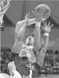  ?? AP Photo/Craig Hudson ?? ■ Texas forward Jaxson Hayes, top, catches a rebound as West Virginia forward Derek Culver (1) reaches during the first half of an NCAA college basketball game Saturday in Morgantown, W.Va.